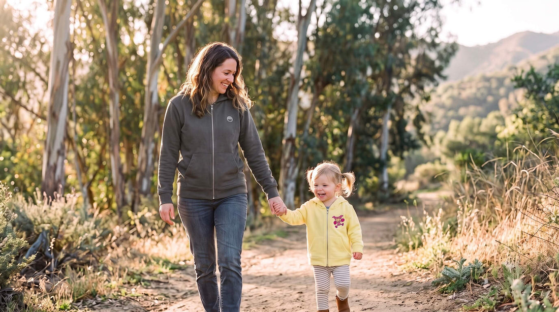 Mother and toddler in matching organic cotton hoodies at Griffith Park, LA, the child wearing a colorful embroidered patch
