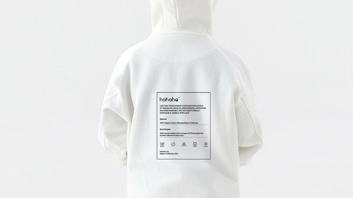 Close-up of a clothing care label showing laundry symbols on a kids garment
