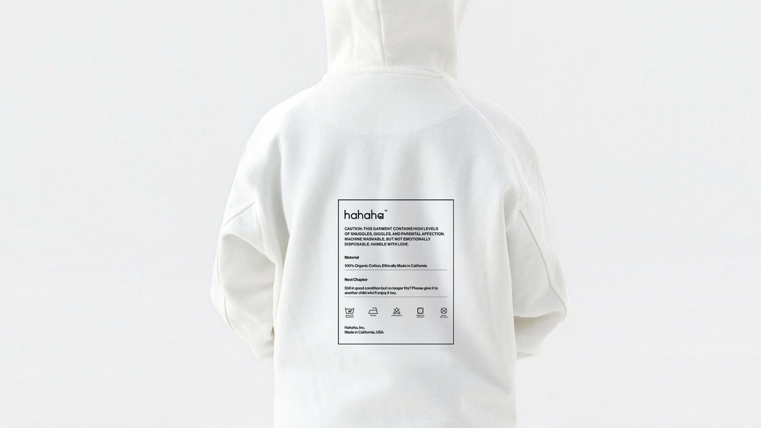 Close-up of a clothing care label showing laundry symbols on a kids garment