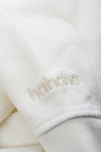 Close-up Hahaha embroidery on organic cotton kids hoodie cuff, handmade in Los Angeles