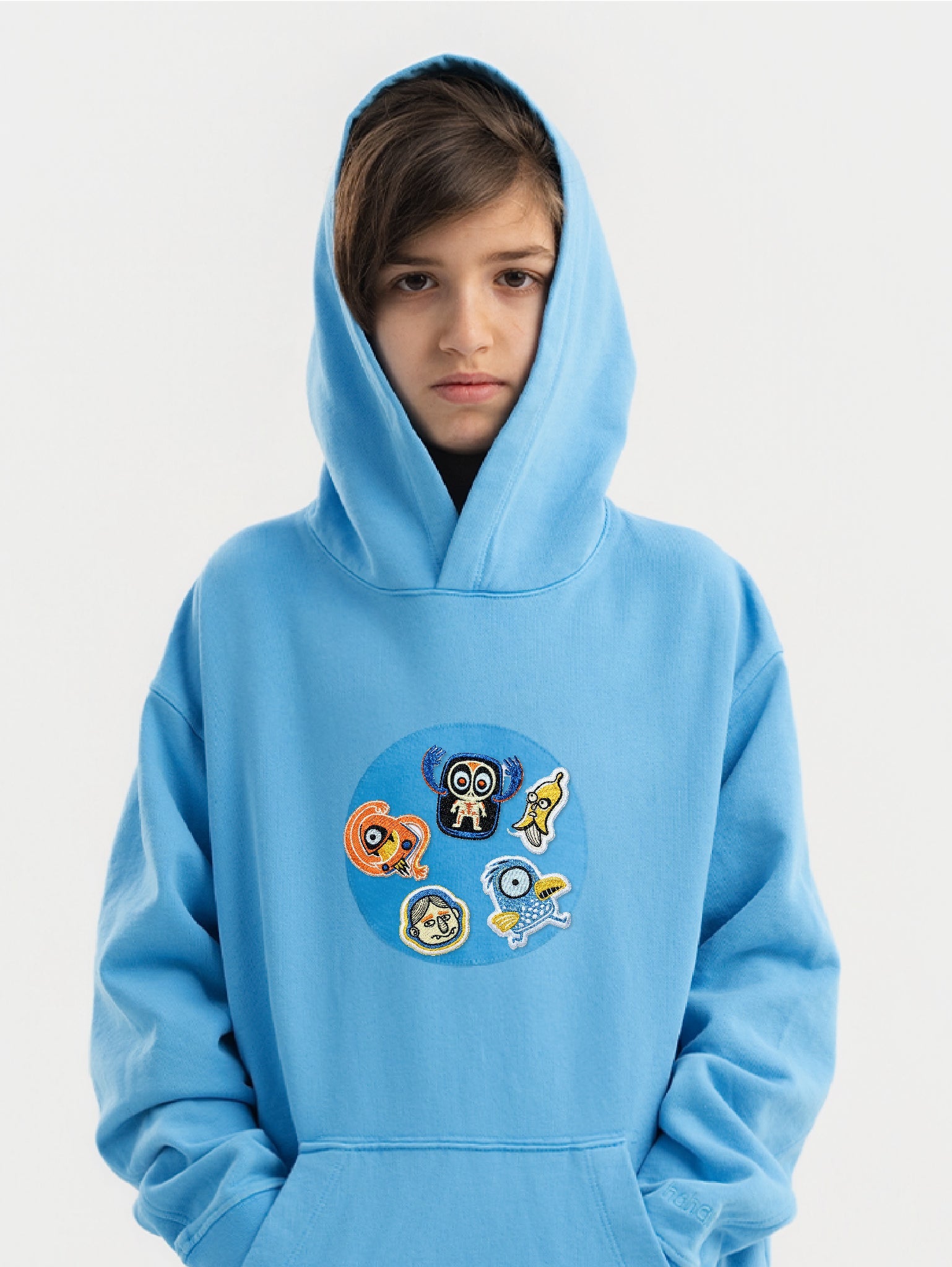 Kid wearing the Freaky Friends patch set on a Hahaha tee