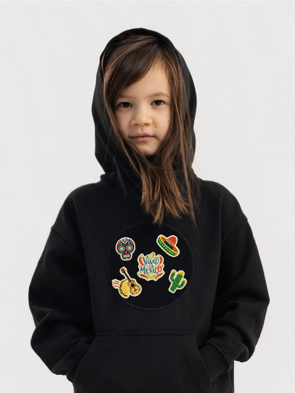 Kid wearing the Viva México patch set on a Hahaha tee