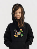 Kid wearing the Viva México patch set on a Hahaha tee