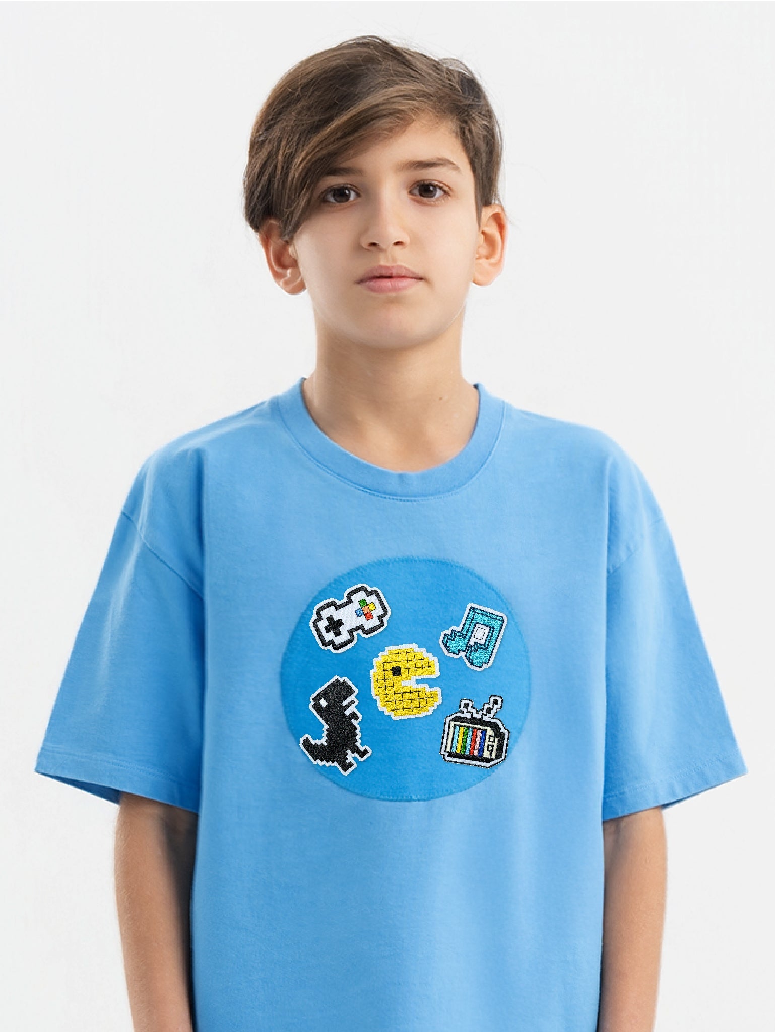 Kid wearing the Pixel Play patch set on a Hahaha tee