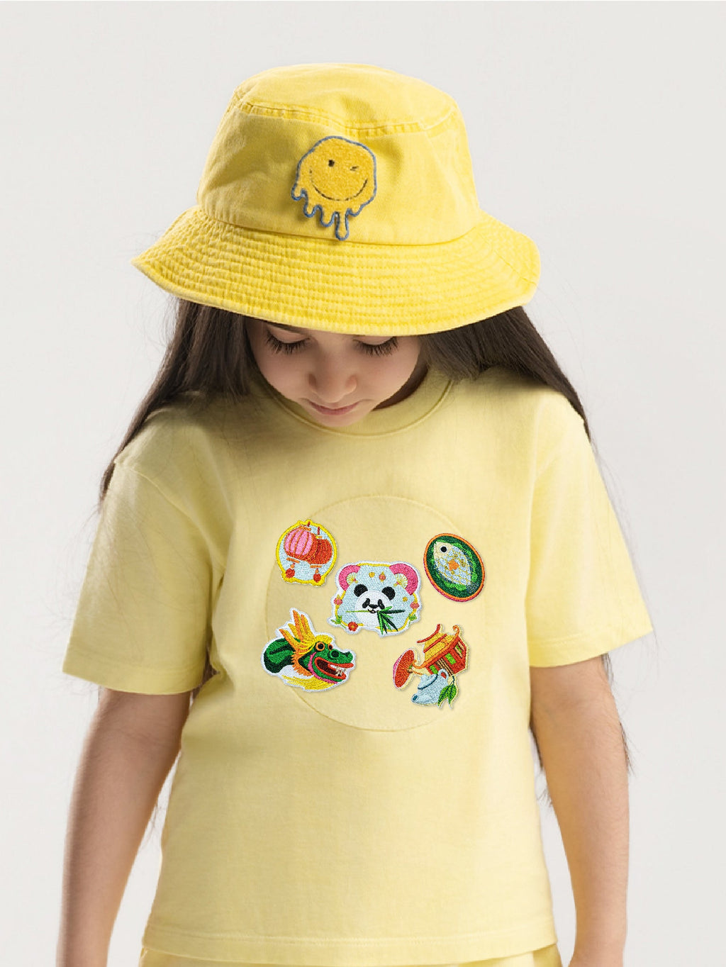 Kid wearing the Dragon Spirit patch set on a Hahaha tee
