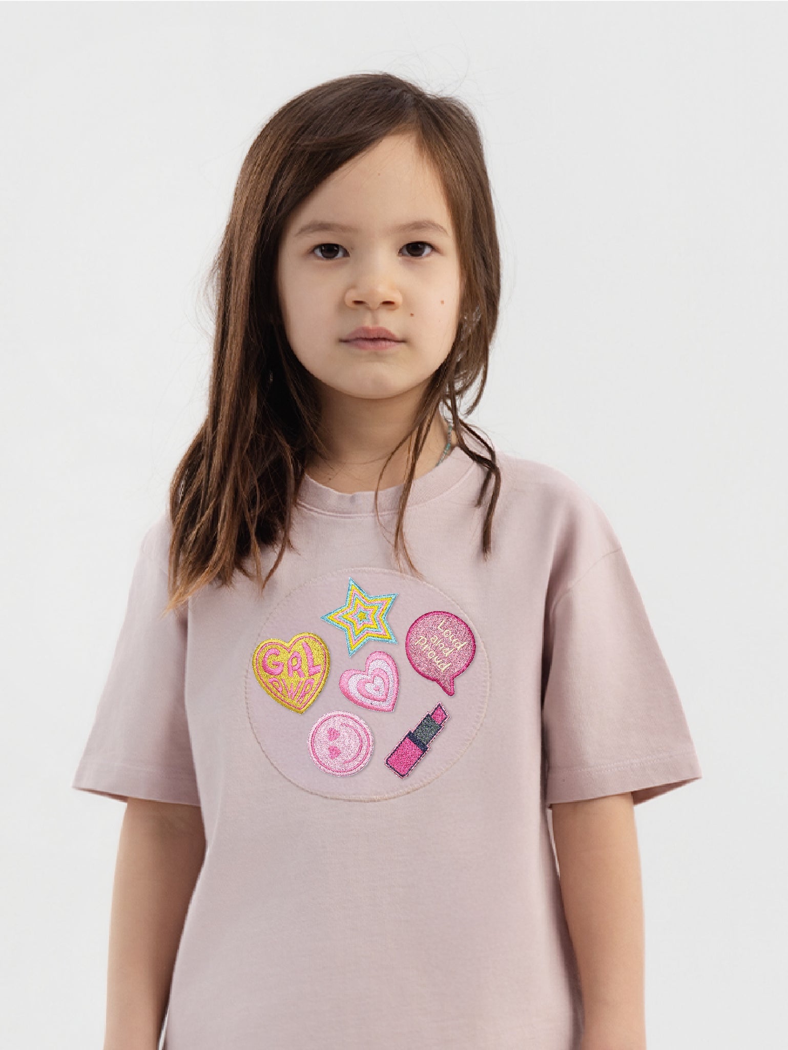 Kid wearing the Girl Power patch set on a Hahaha tee