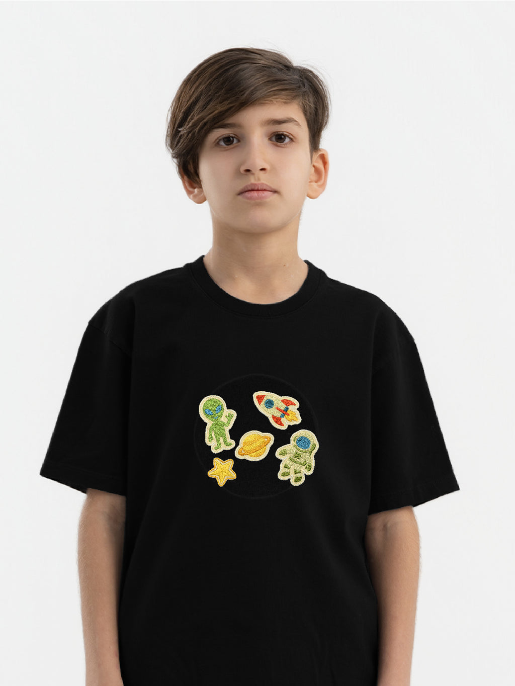 Child wearing organic cotton Hahaha hoodie with Space Explorer collectible patches on swappable zone
