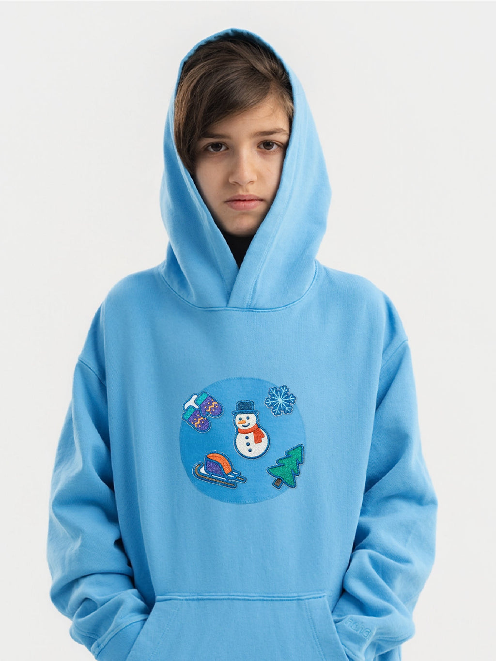 Kid wearing the Snowy Winter patch set on a Hahaha tee