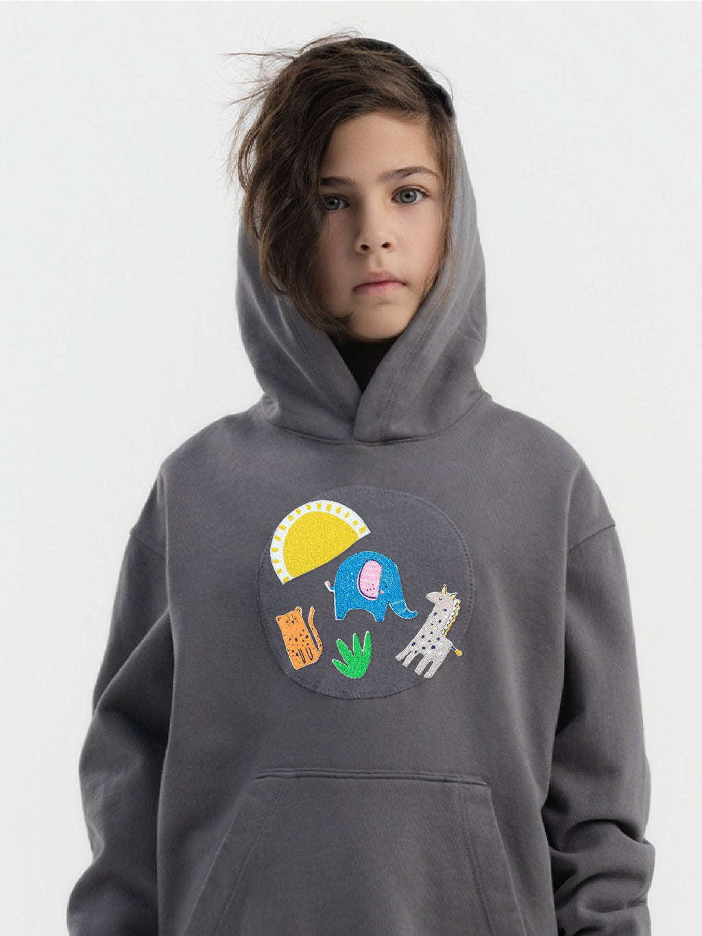 Kid wearing the Safari Snuggles patch set on a Hahaha tee