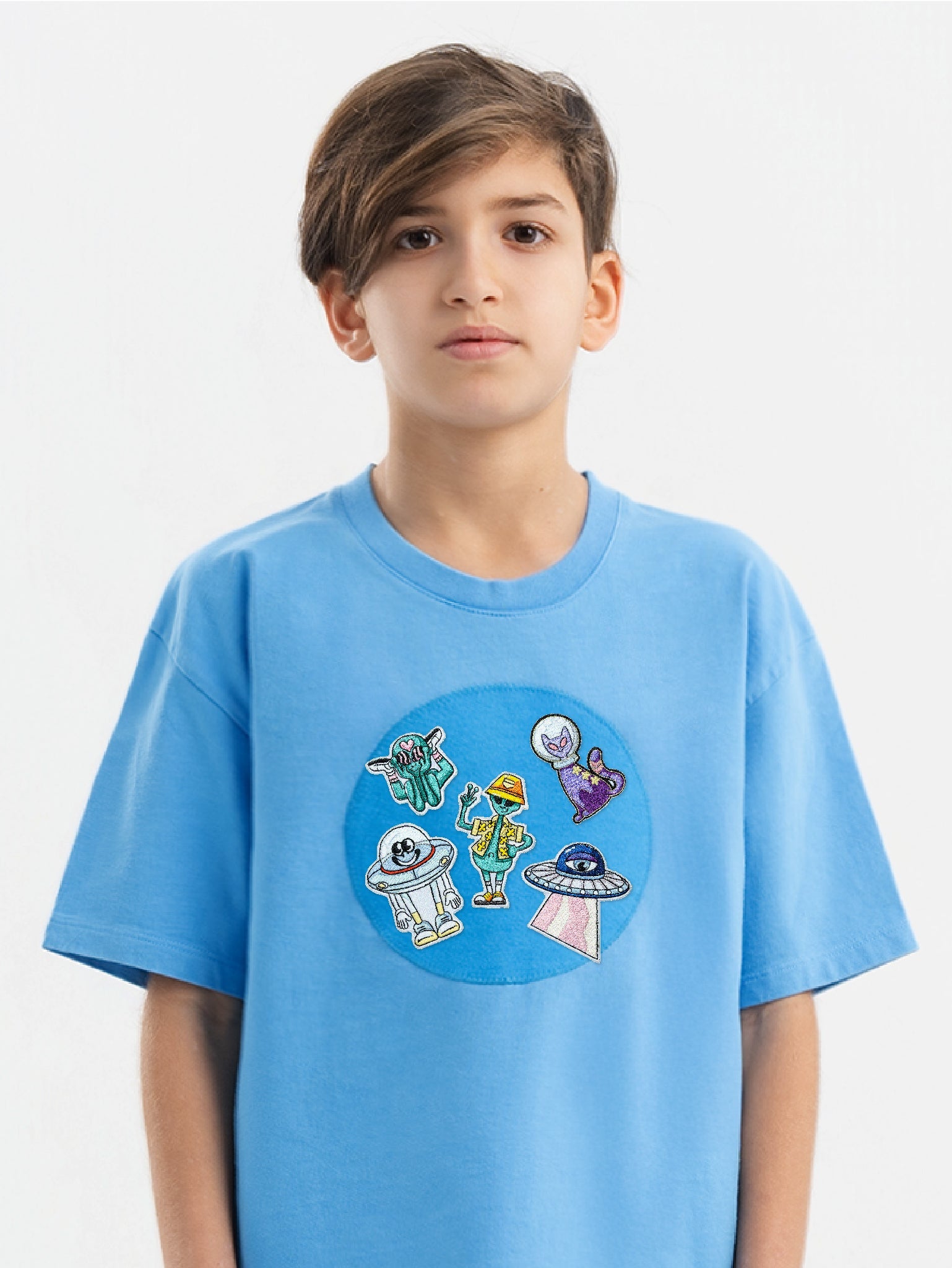Kid wearing the Alien Adventure patch set on a Hahaha tee