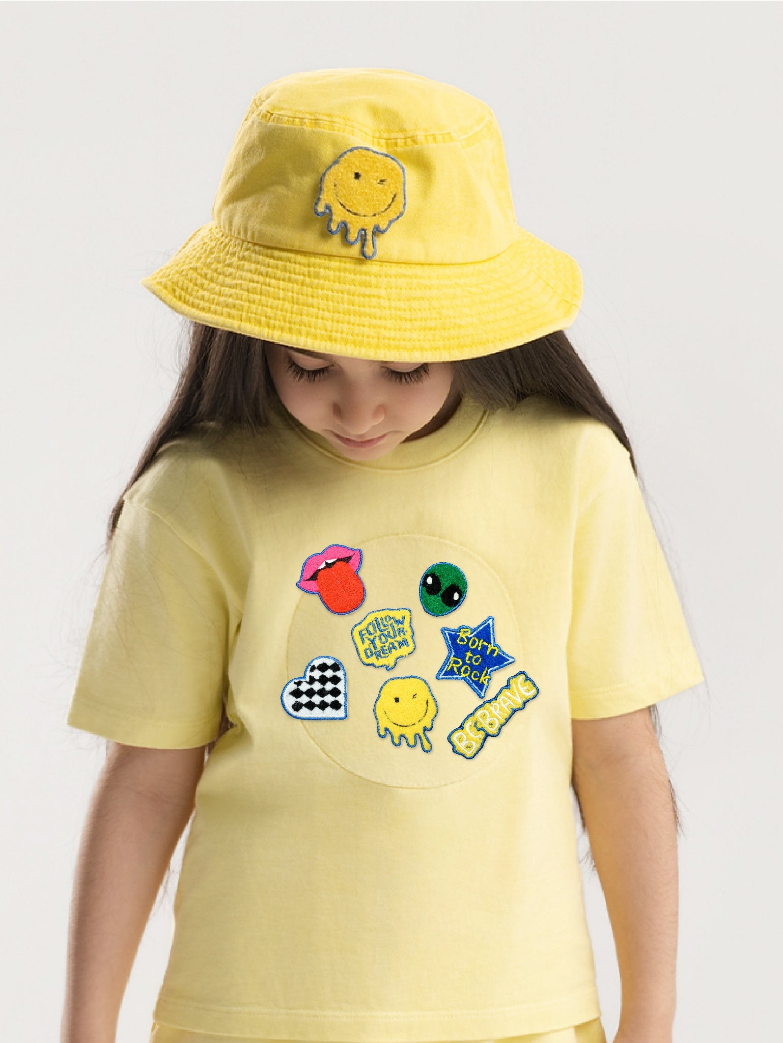 Kid wearing the Born to Rock patch set on a Hahaha tee
