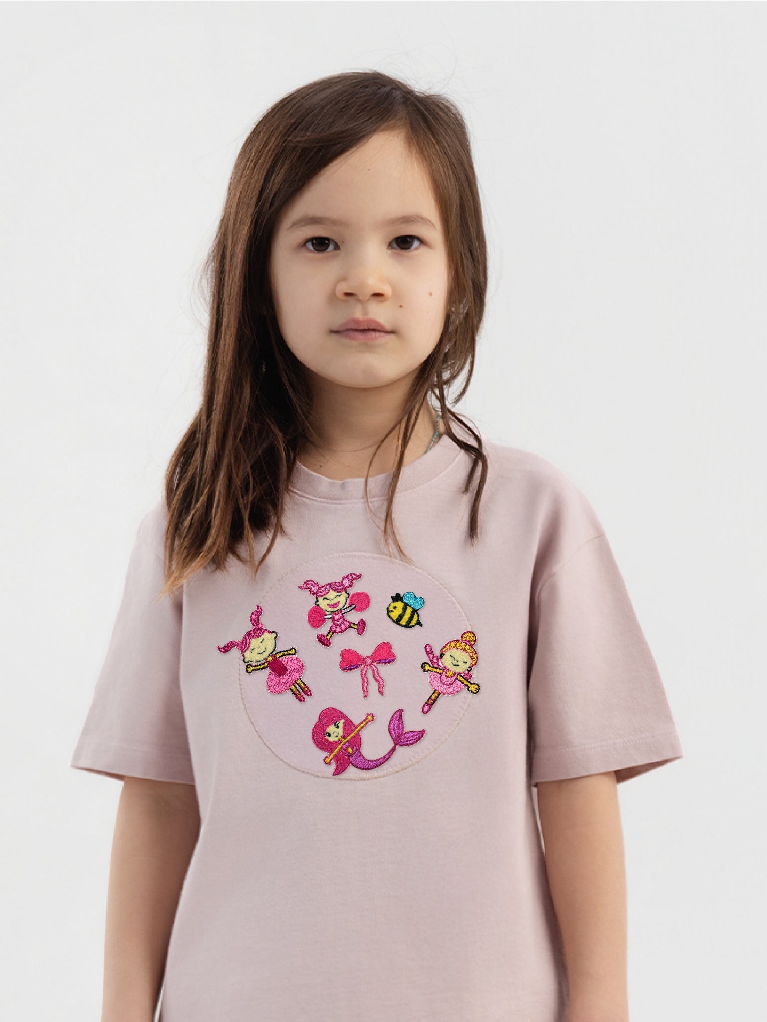 Kid wearing the Ella and the Bee patch set on a Hahaha tee