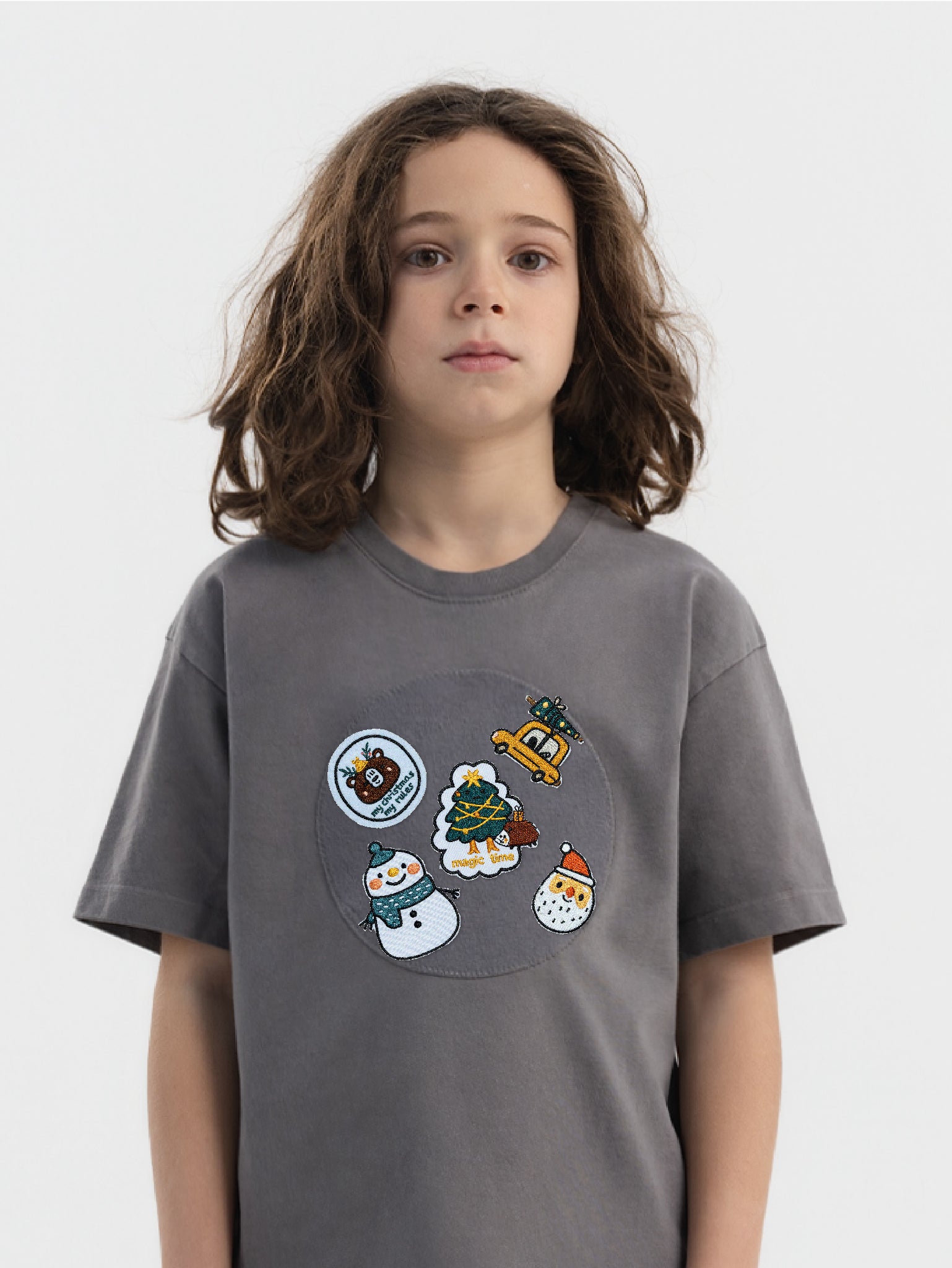 Kid wearing the Santa Squad patch set on a Hahaha tee