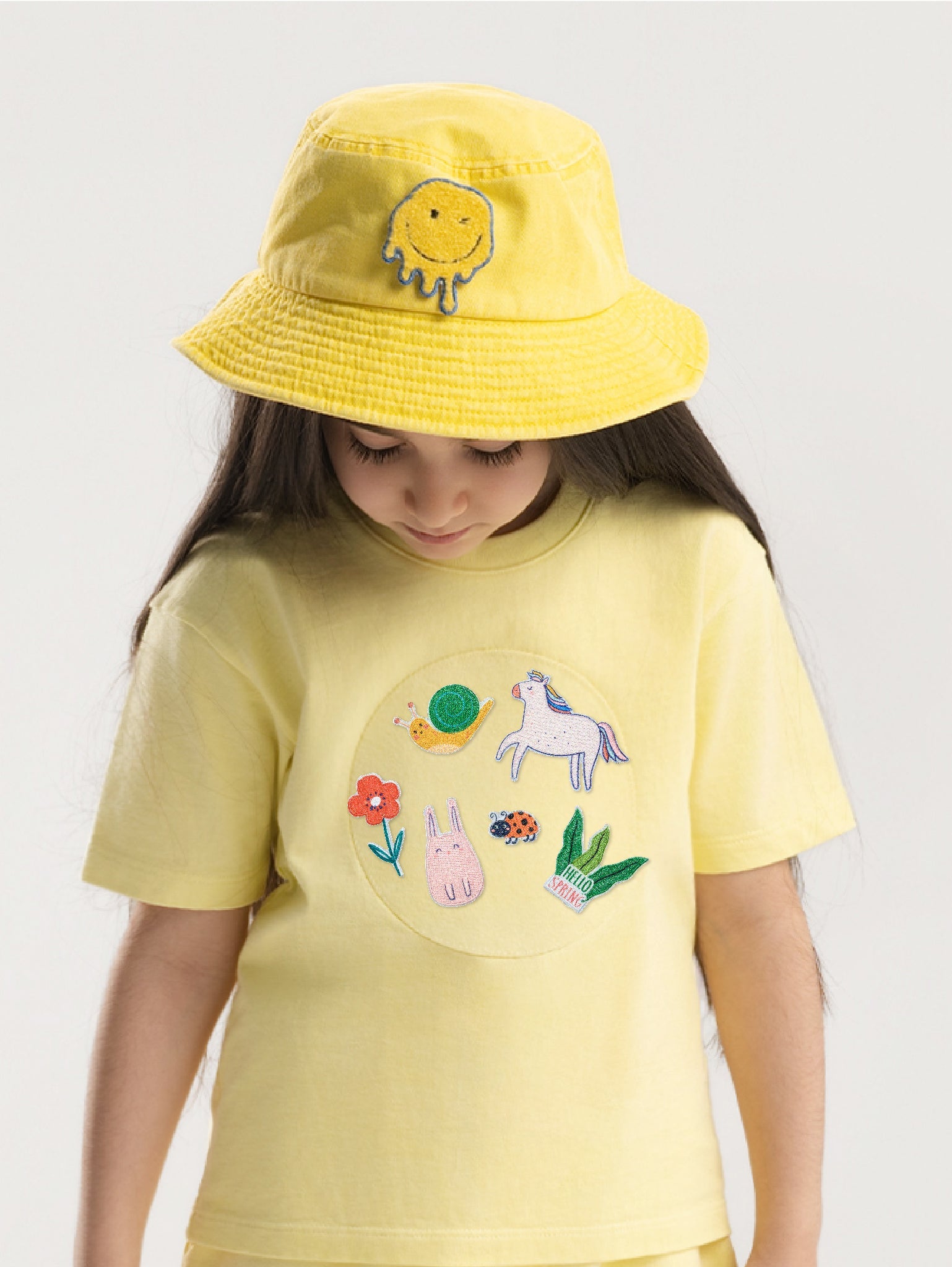 Kid wearing the Hello Spring patch set on a Hahaha tee