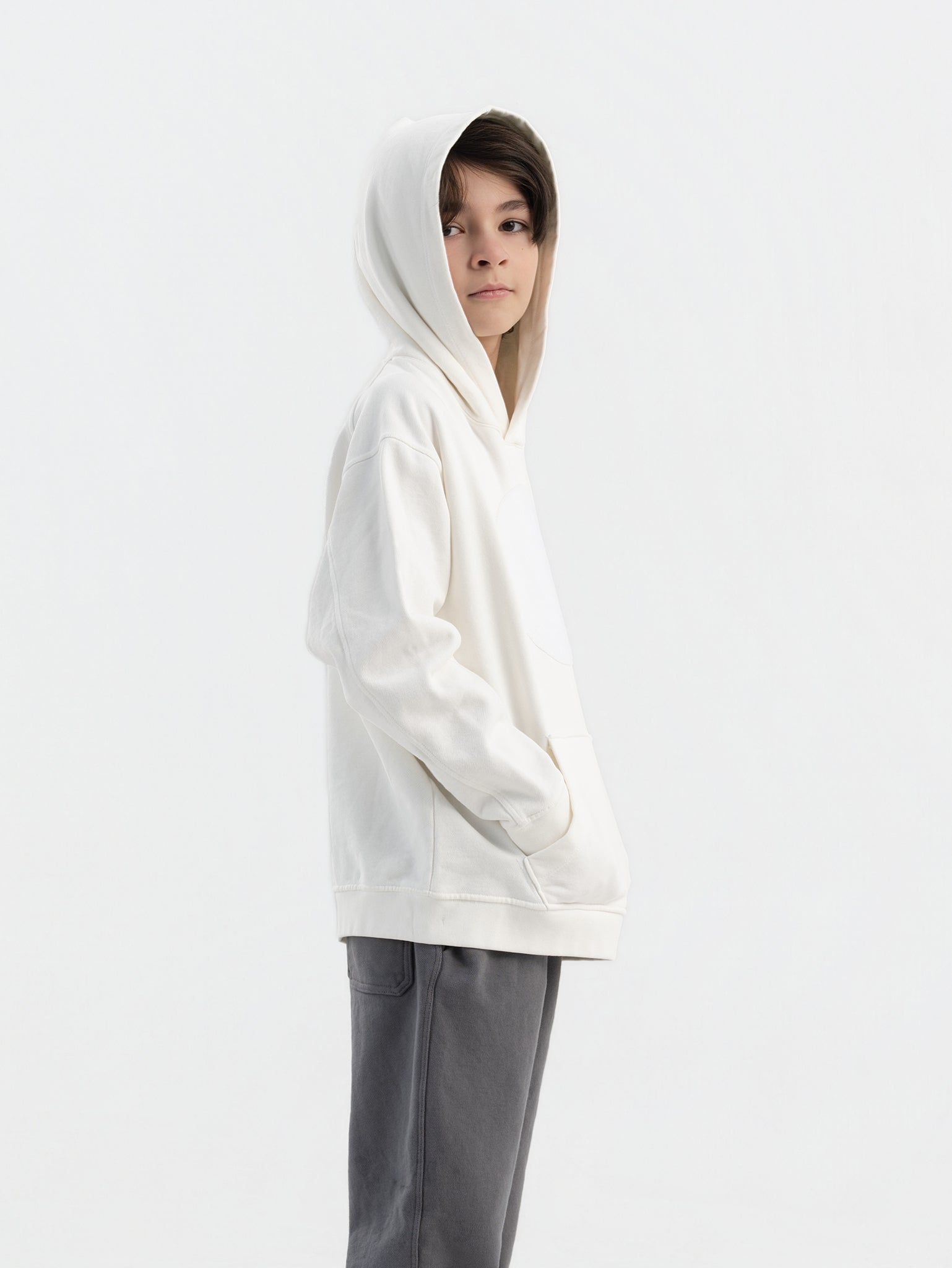 Child wearing off white Hahaha hoodie with collectible patches on swappable circular patch zone
