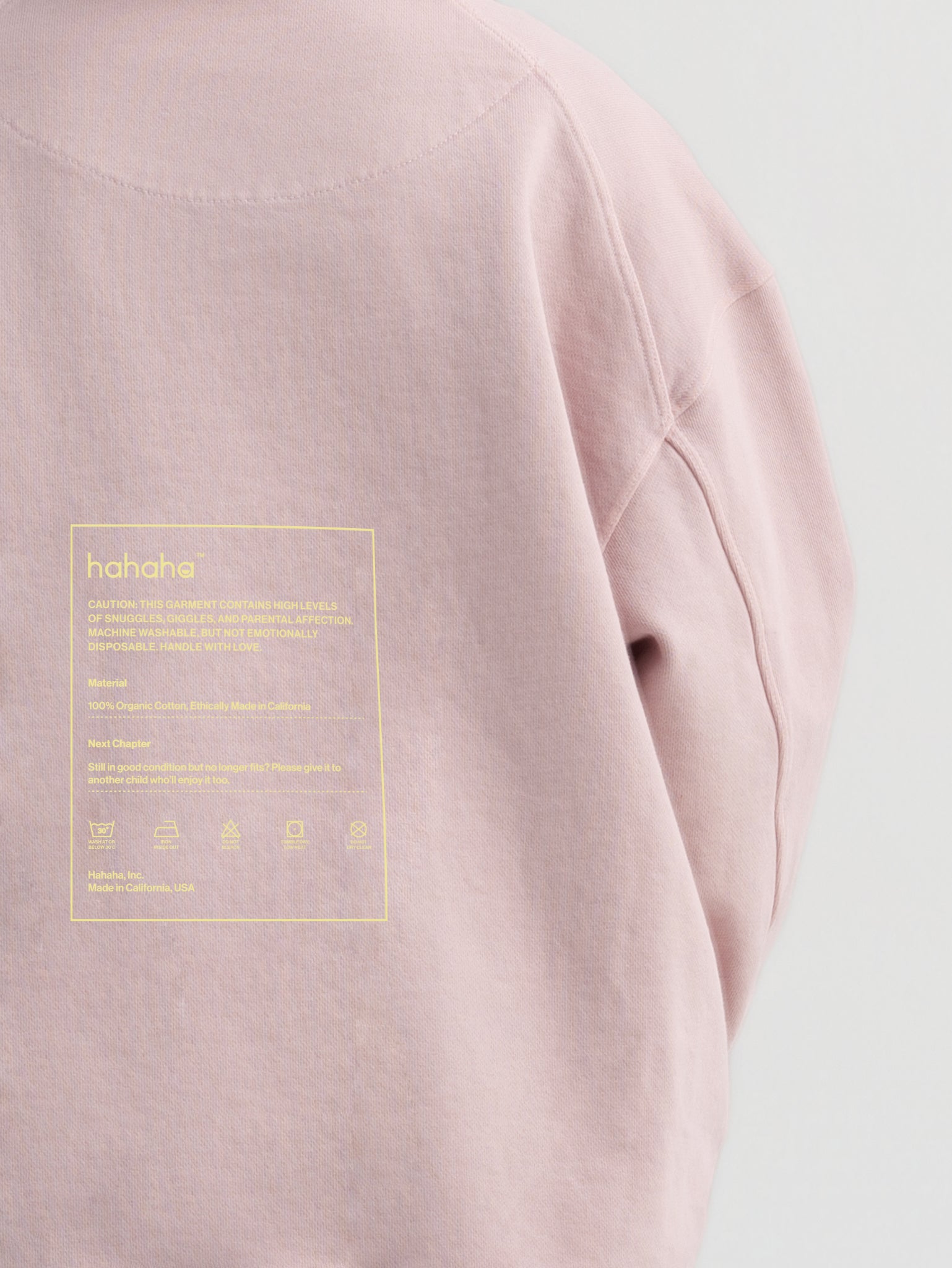 Close-up of circular swappable patch zone texture on dirty pink Hahaha organic cotton kids hoodie