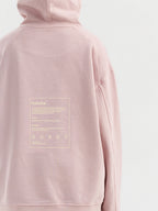 Back of dirty pink Hahaha kids hoodie with CAUTION CONTAINS HIGH LEVELS OF SNUGGLES AND GIGGLES label