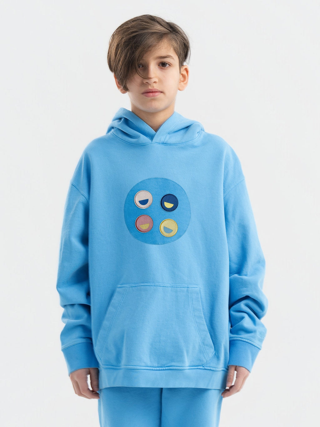 Kid wearing the Hahaha Emblem patch set on a Hahaha tee