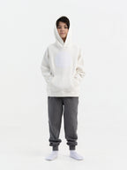 Child wearing off white Hahaha organic cotton hoodie with joggers, front view, made in Los Angeles