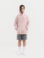 Child wearing dirty pink Hahaha organic cotton hoodie with joggers, front view, made in Los Angeles