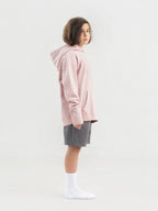 Dirty Pink Hahaha organic cotton kids hoodie side profile, child looking over shoulder