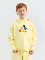 Close-up Hahaha embroidery on organic cotton kids hoodie cuff, handmade in Los Angeles