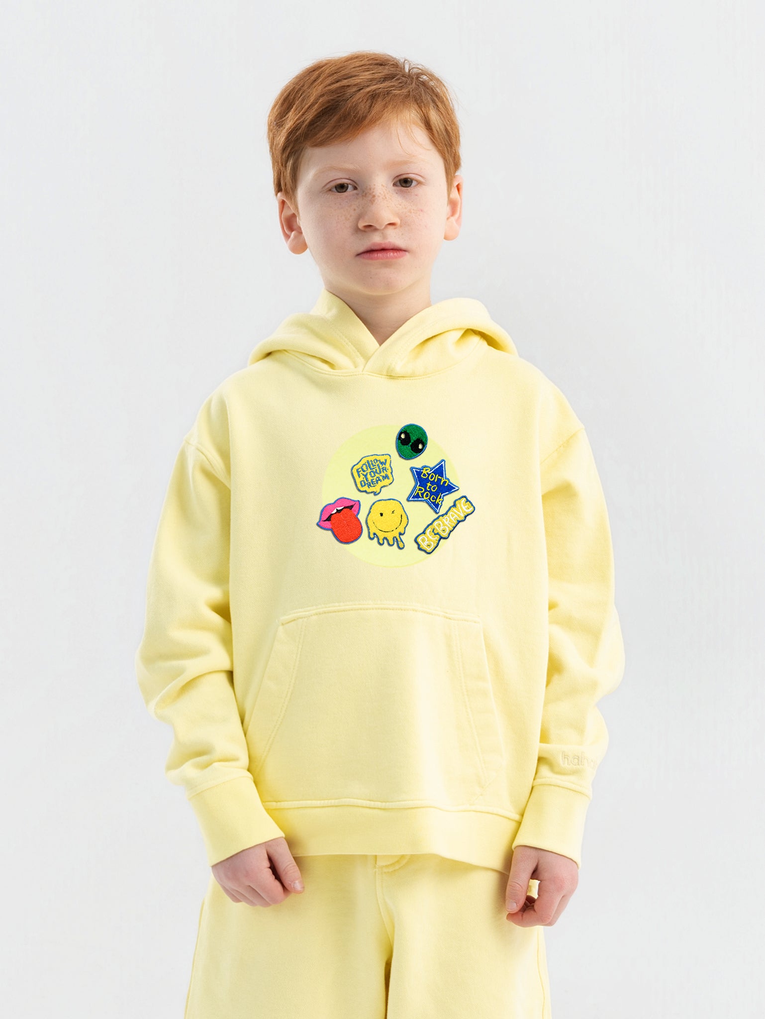 Close-up Hahaha embroidery on organic cotton kids hoodie cuff, handmade in Los Angeles