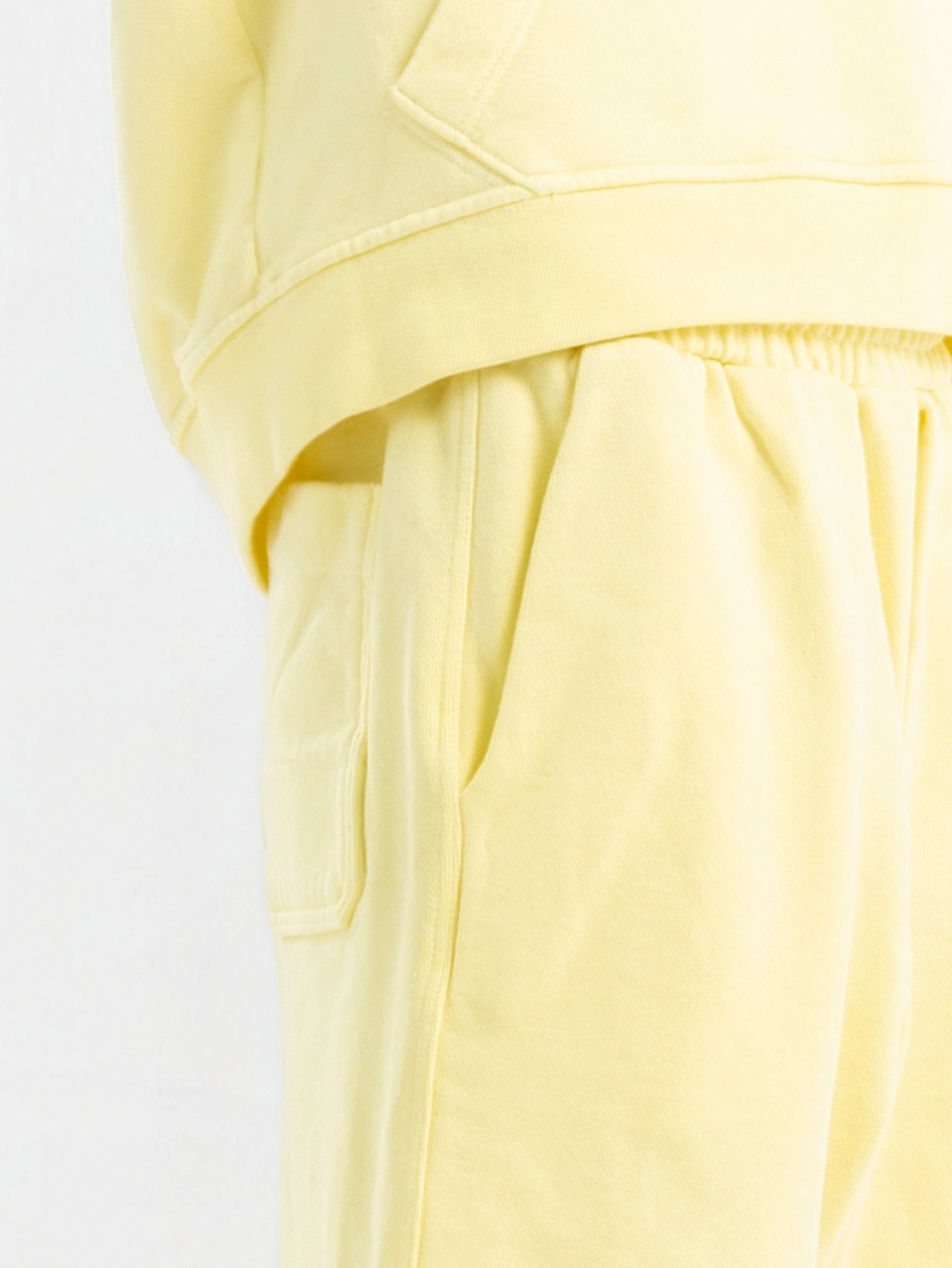 Close-up of circular swappable patch zone texture on light yellow Hahaha organic cotton kids hoodie