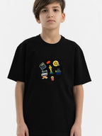 Boy wearing a black organic cotton Hahaha kids T-shirt with movie-themed embroidered patches on the chest
