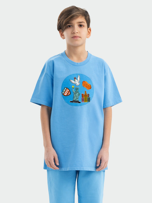Child wearing blue Hahaha tee with collectible patches on swappable circular patch zone